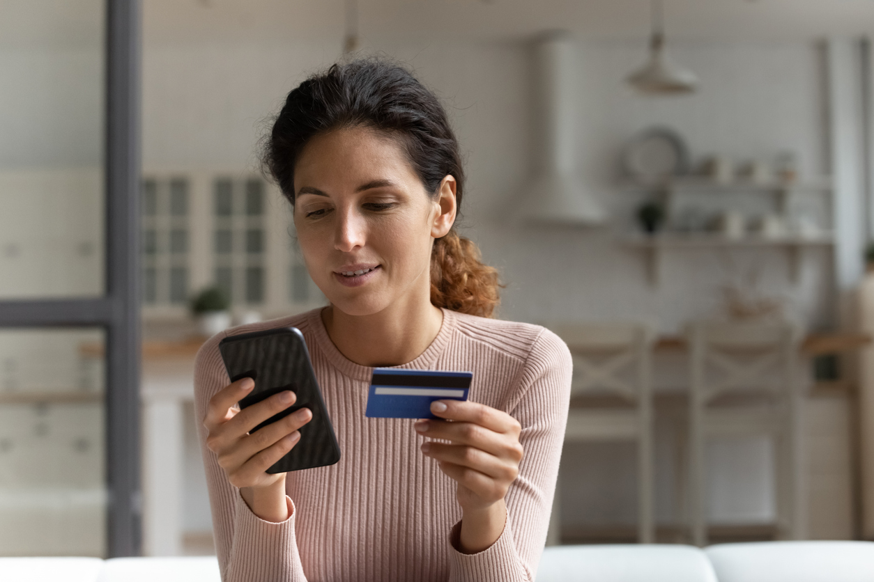 Woman making a payment on a cell phone