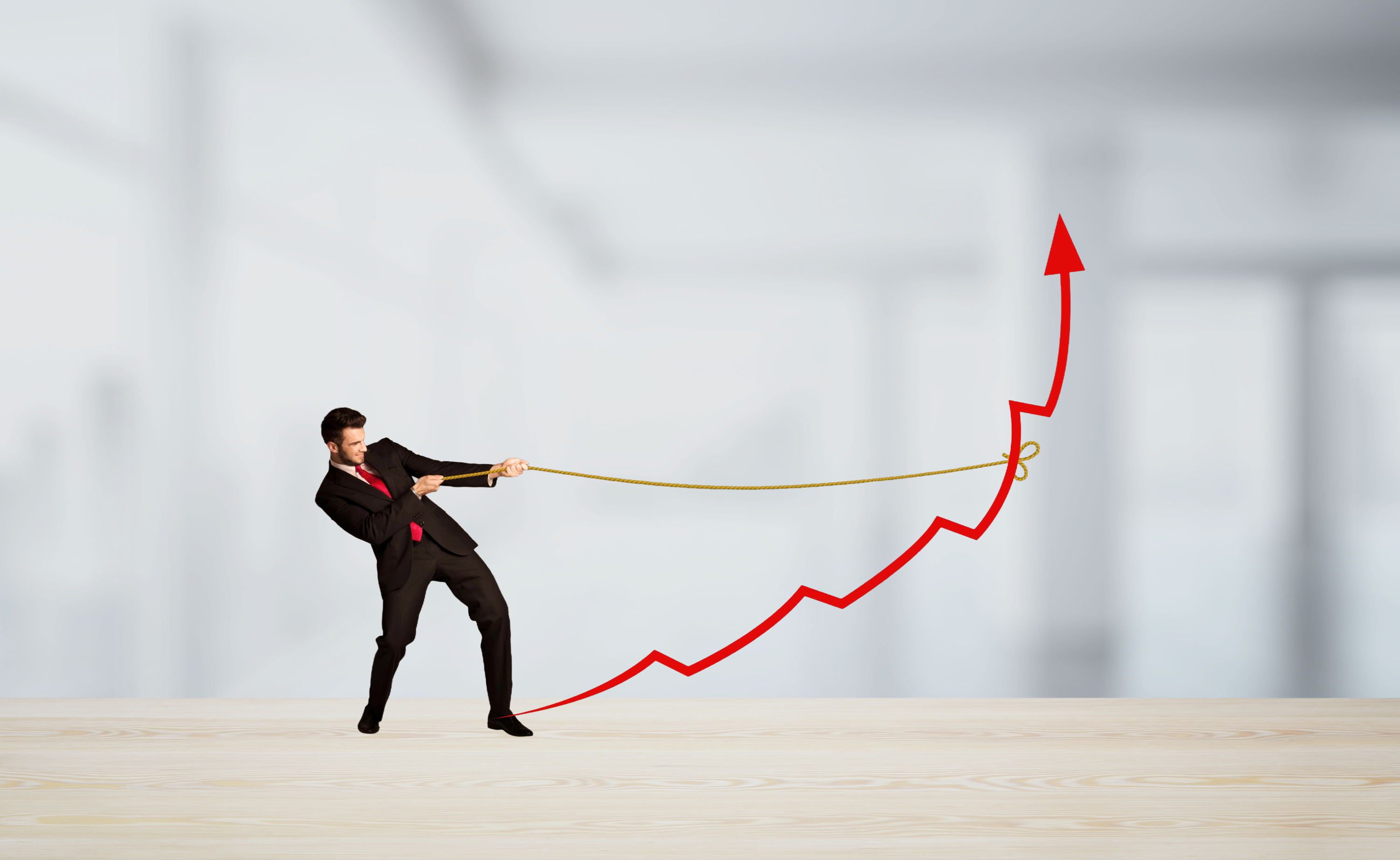 Businessman pulling a red arrow upright with a rope. Business concept.
