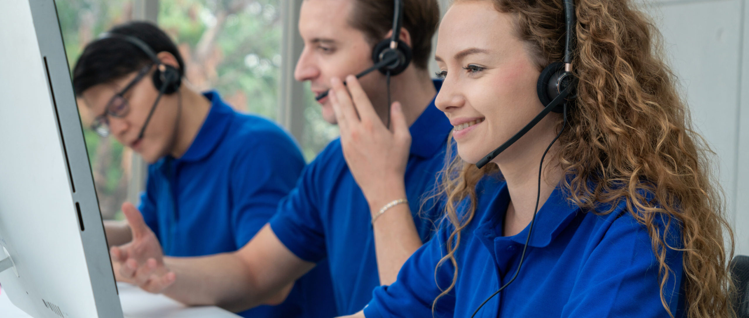 Business people wearing headset working in office to support remote customer or colleague. Call center, telemarketing, customer support agent provide service on telephone video conference call.