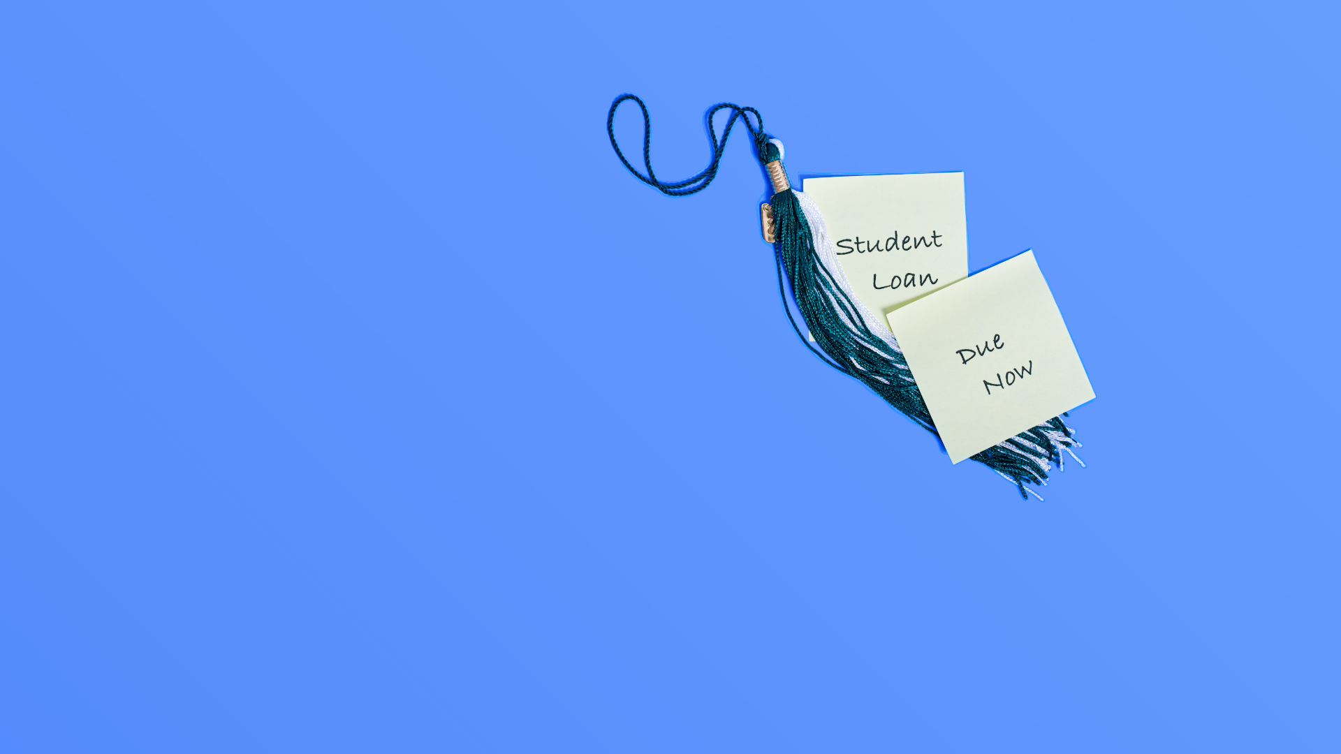 Debt reminder slips labeled 'Student Loan' 'Due Now' affixed to graduation cap tassel