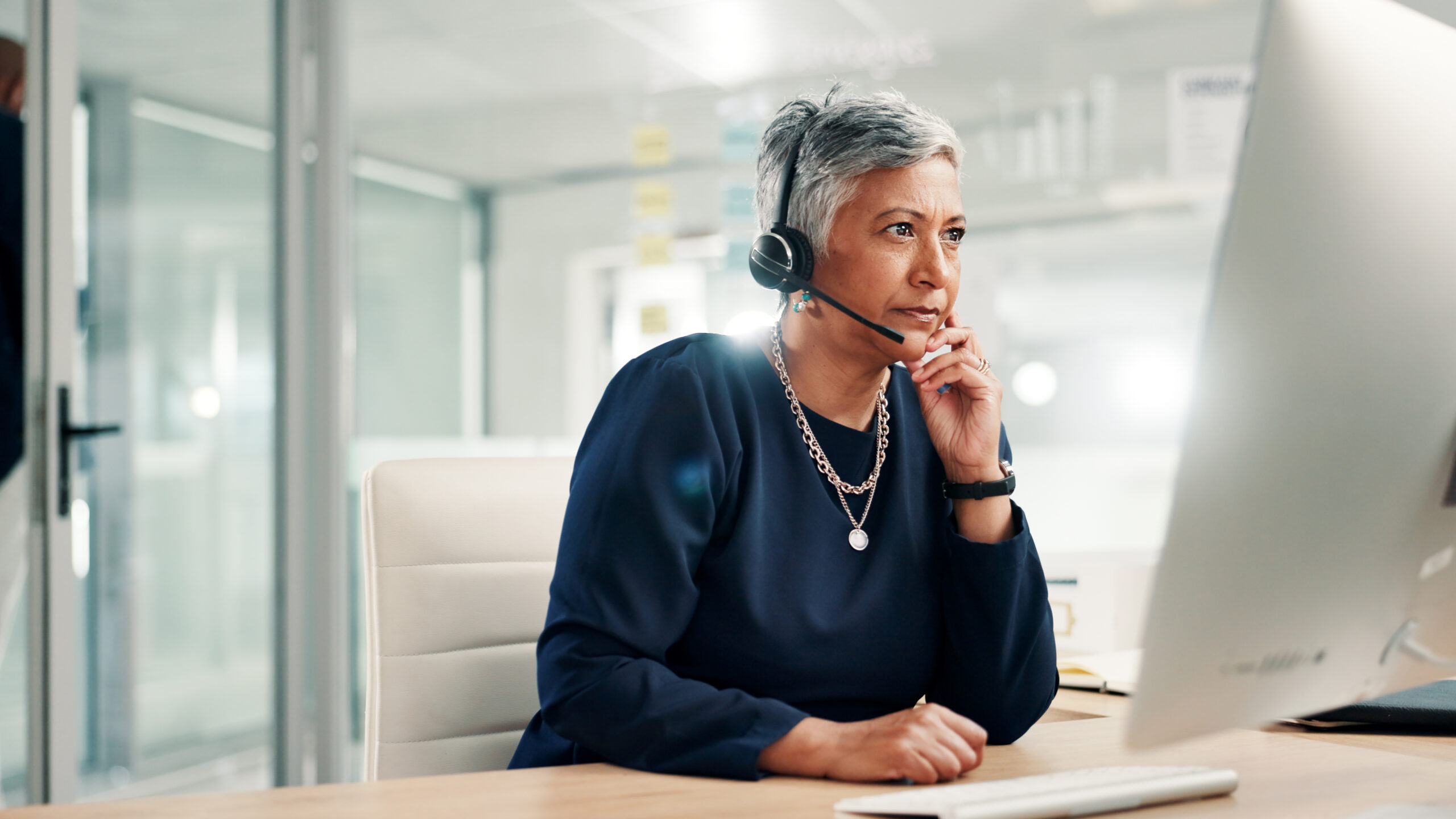 mature woman on computer for contact us, crm service and customer support. Business, professional consultant and person with headset for communication, advice and feedback